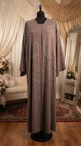 Long brown dress on a mannequin in a room with decorative curtains and a mirror.